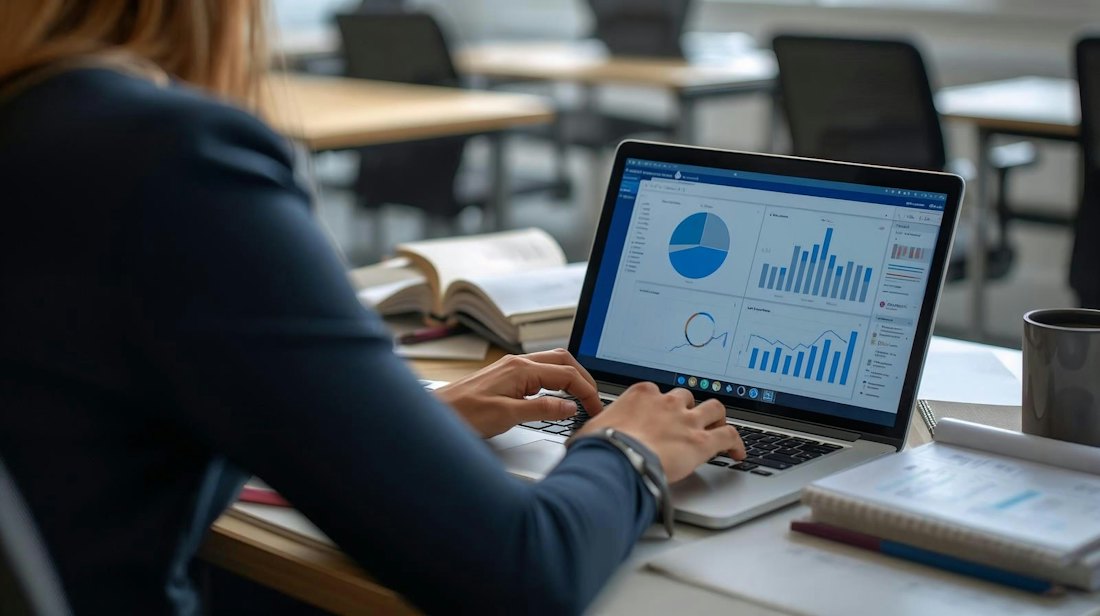 An analyst reviewing data on a laptop