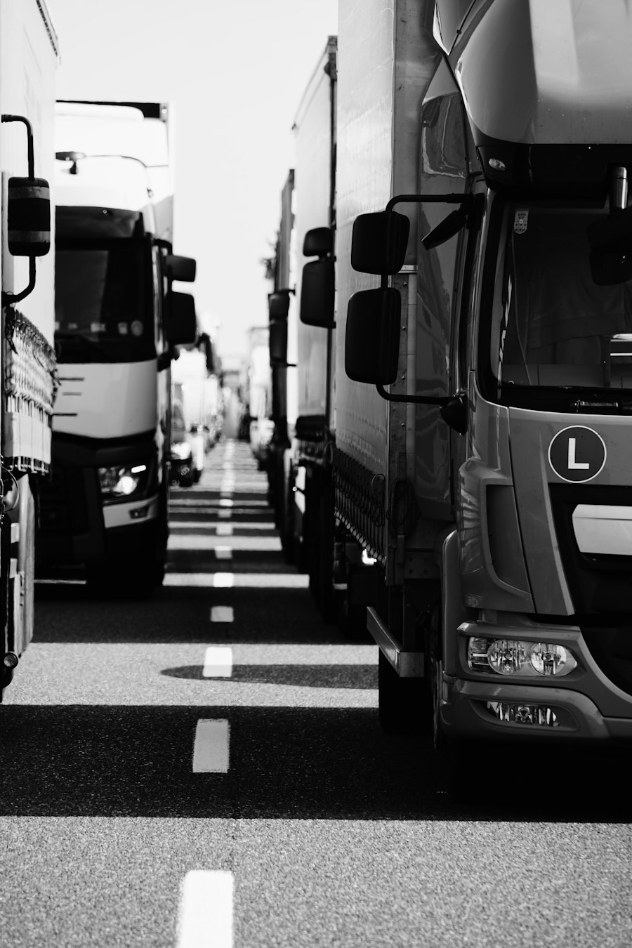 A convoy of freight trucks on a highway